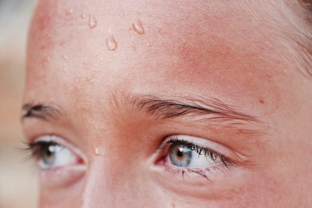 Close-up of sweating woman's forehead